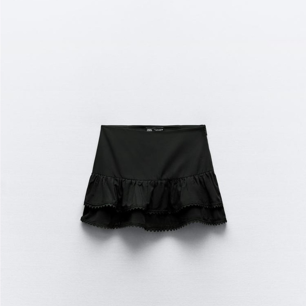 Two Ruffle mini skirts (black and white) one of each